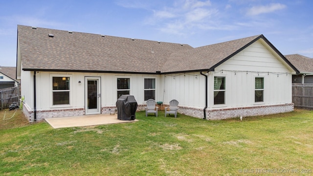 rear view of house with a yard and a patio area