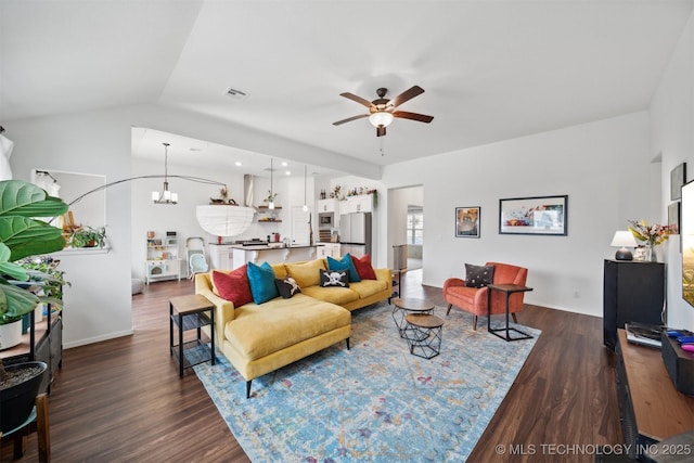 living room with lofted ceiling, dark hardwood / wood-style floors, and ceiling fan with notable chandelier