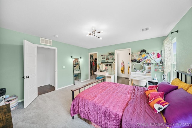 bedroom featuring carpet flooring, a closet, and a spacious closet