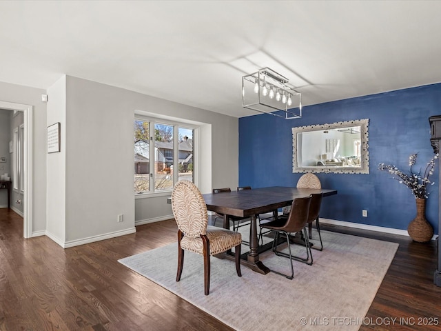 dining area featuring dark wood-type flooring