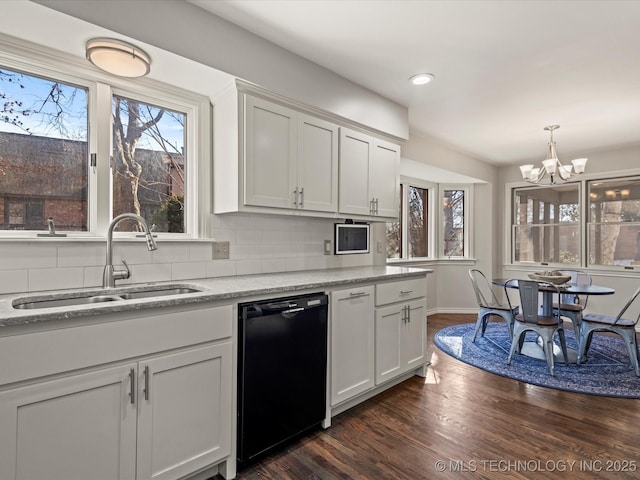 kitchen featuring white cabinetry, black dishwasher, an inviting chandelier, decorative backsplash, and sink