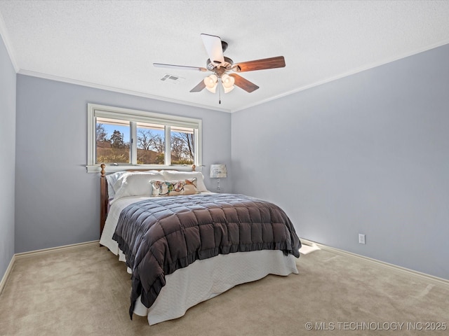 carpeted bedroom featuring ceiling fan, ornamental molding, and a textured ceiling