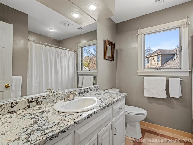 bathroom with toilet, tile patterned floors, and vanity