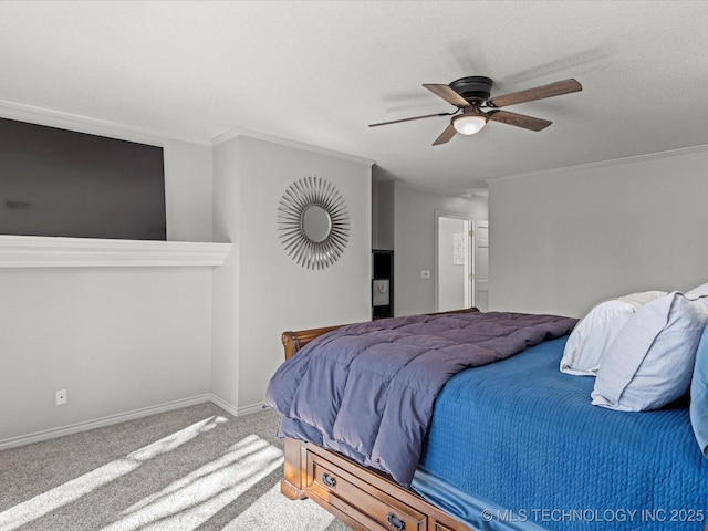 carpeted bedroom featuring ceiling fan and crown molding