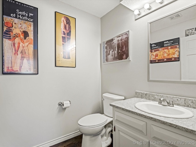 bathroom with toilet and vanity