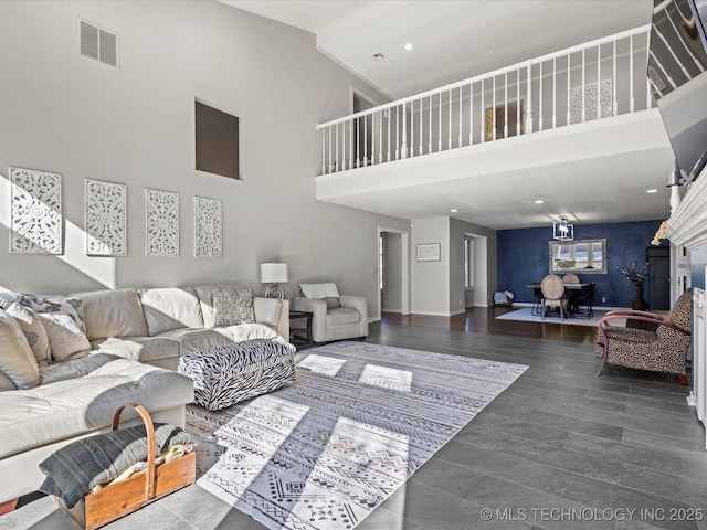 living room featuring dark wood-type flooring and a high ceiling