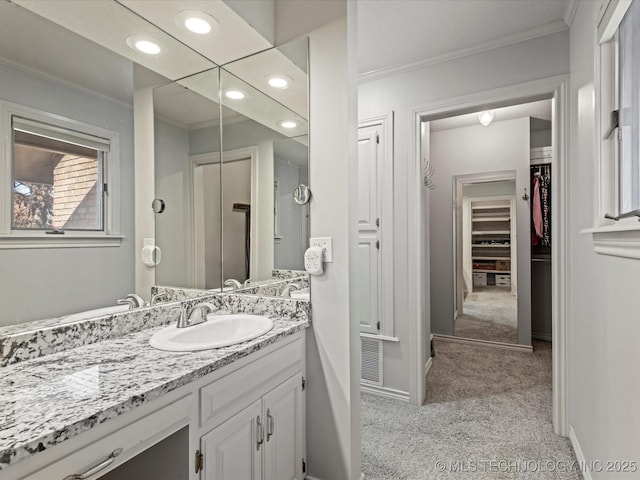 bathroom featuring ornamental molding and vanity