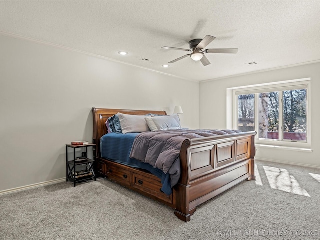 bedroom featuring ceiling fan, light colored carpet, a textured ceiling, and crown molding