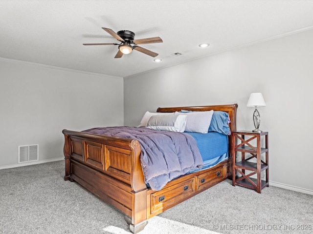 carpeted bedroom with ceiling fan and ornamental molding