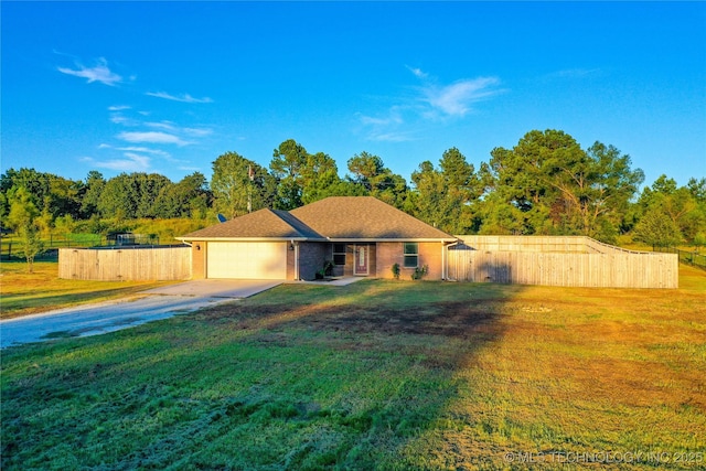 single story home featuring a garage and a front yard