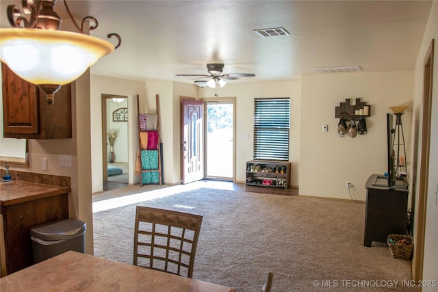 living room with light carpet and ceiling fan