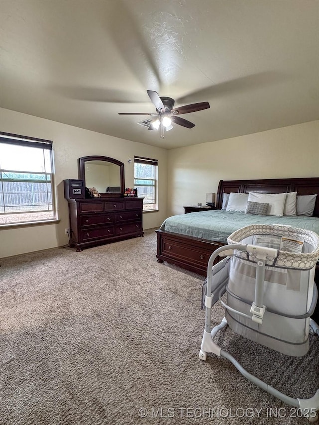 carpeted bedroom with ceiling fan