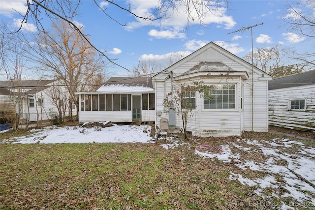 view of front of house featuring a sunroom and a yard