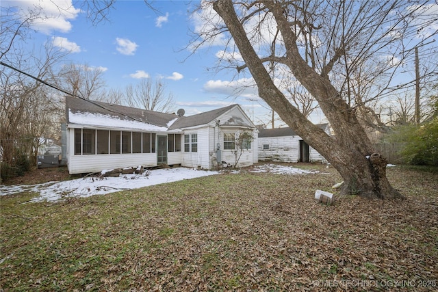 rear view of house featuring a sunroom