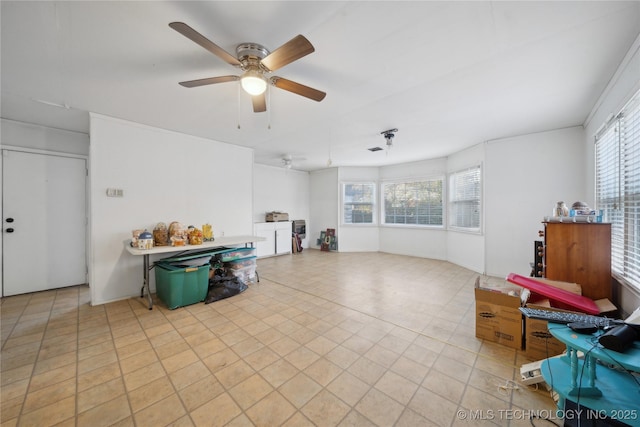 living room with ceiling fan and a healthy amount of sunlight