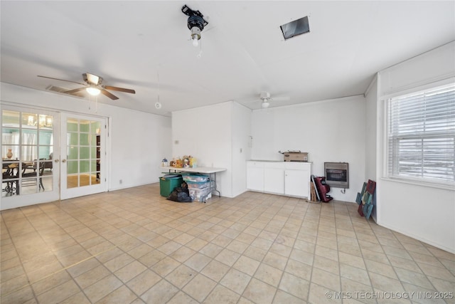 interior space with ceiling fan, french doors, heating unit, and area for grilling