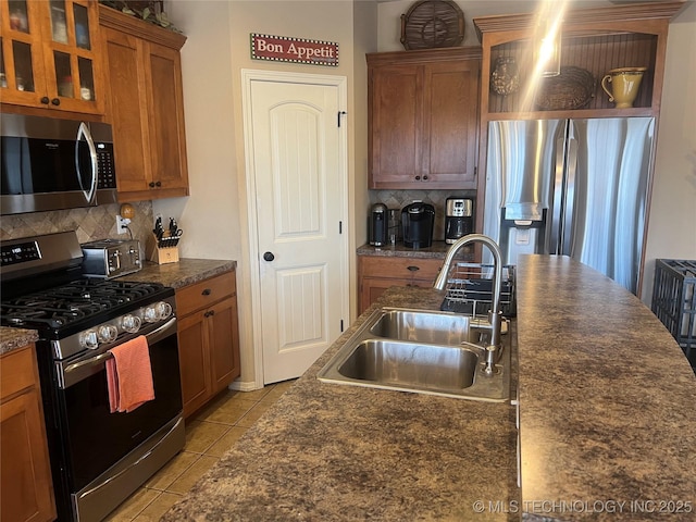 kitchen featuring sink, light tile patterned floors, stainless steel appliances, and tasteful backsplash