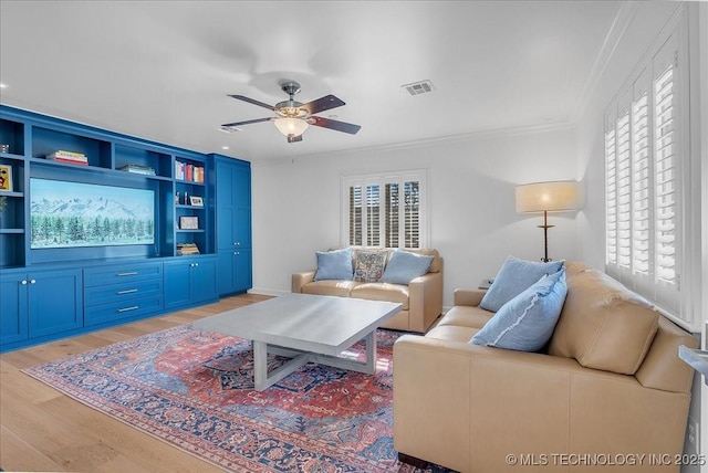 living room featuring light wood-type flooring, ceiling fan, and ornamental molding