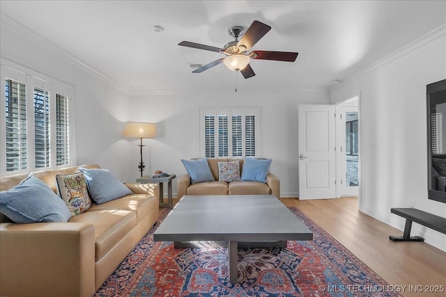 living room with ceiling fan, light hardwood / wood-style flooring, and ornamental molding