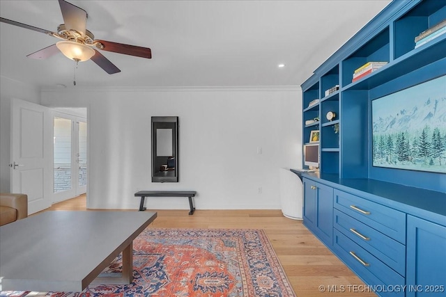 home office with ceiling fan, ornamental molding, and light wood-type flooring