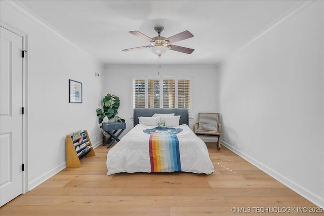 bedroom featuring ceiling fan, light hardwood / wood-style floors, and crown molding