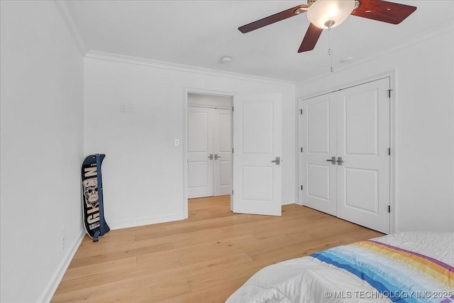 bedroom with ceiling fan, hardwood / wood-style flooring, and ornamental molding