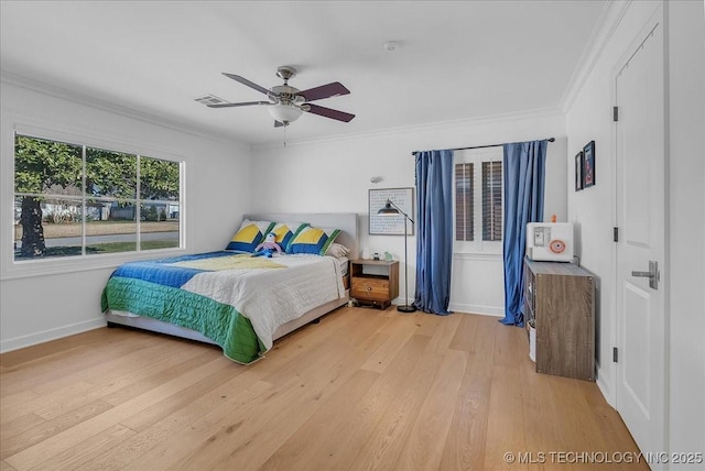 bedroom with ceiling fan, ornamental molding, and wood-type flooring