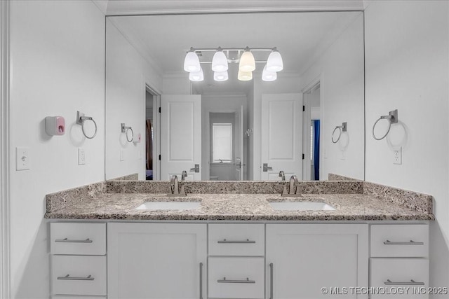 bathroom featuring crown molding and vanity