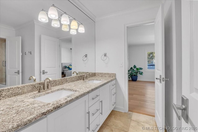 bathroom with tile patterned floors, vanity, and ornamental molding