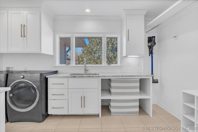 washroom with light tile patterned floors, cabinets, ornamental molding, washer / clothes dryer, and sink