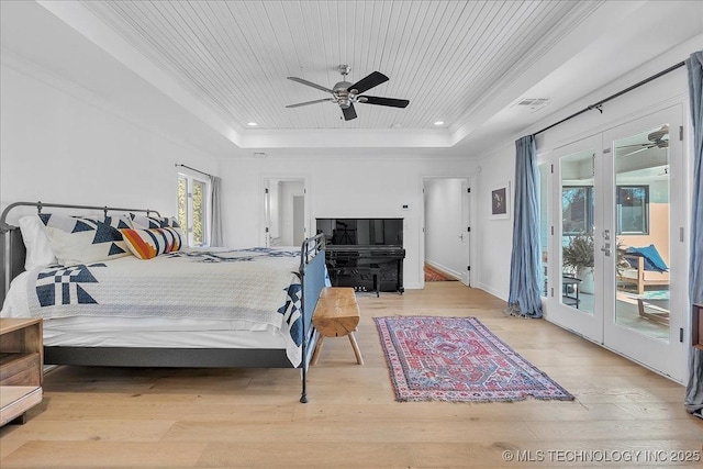 bedroom with a raised ceiling, access to exterior, wooden ceiling, and ceiling fan