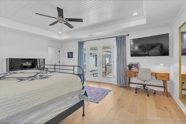 bedroom with access to outside, ceiling fan, crown molding, and a tray ceiling