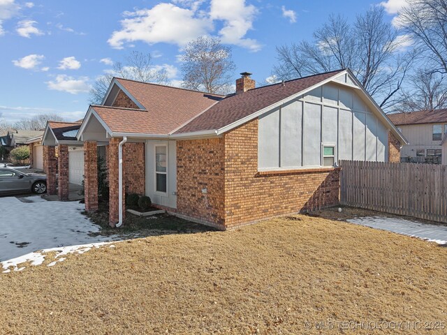 view of side of home with a yard and a garage