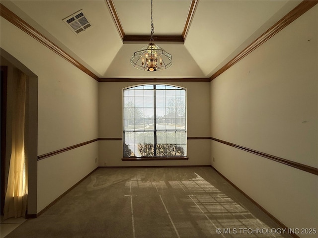 empty room featuring lofted ceiling, carpet floors, ornamental molding, and a chandelier