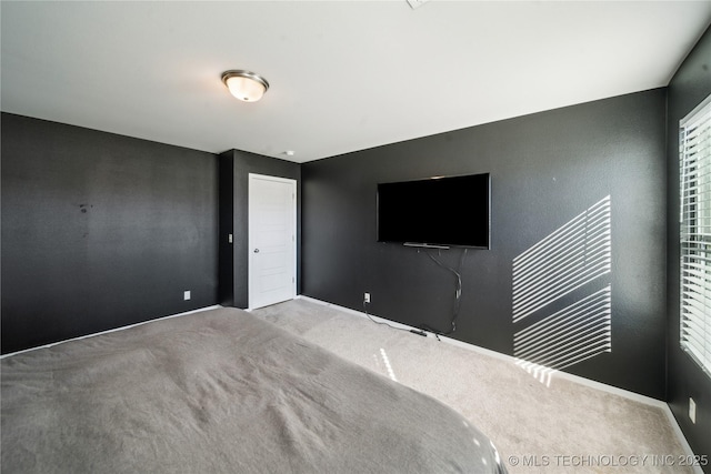 unfurnished bedroom featuring light colored carpet