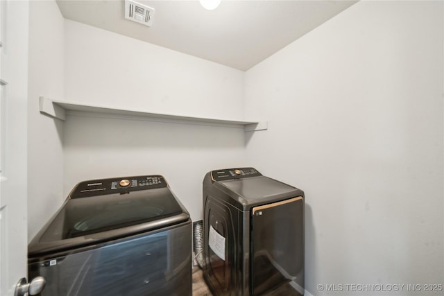 washroom with independent washer and dryer