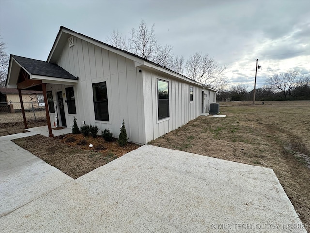 view of side of home with central air condition unit