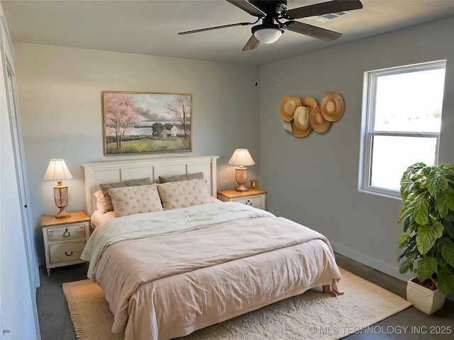 bedroom with ceiling fan and multiple windows