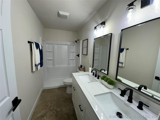 bathroom featuring toilet, vanity, and a shower