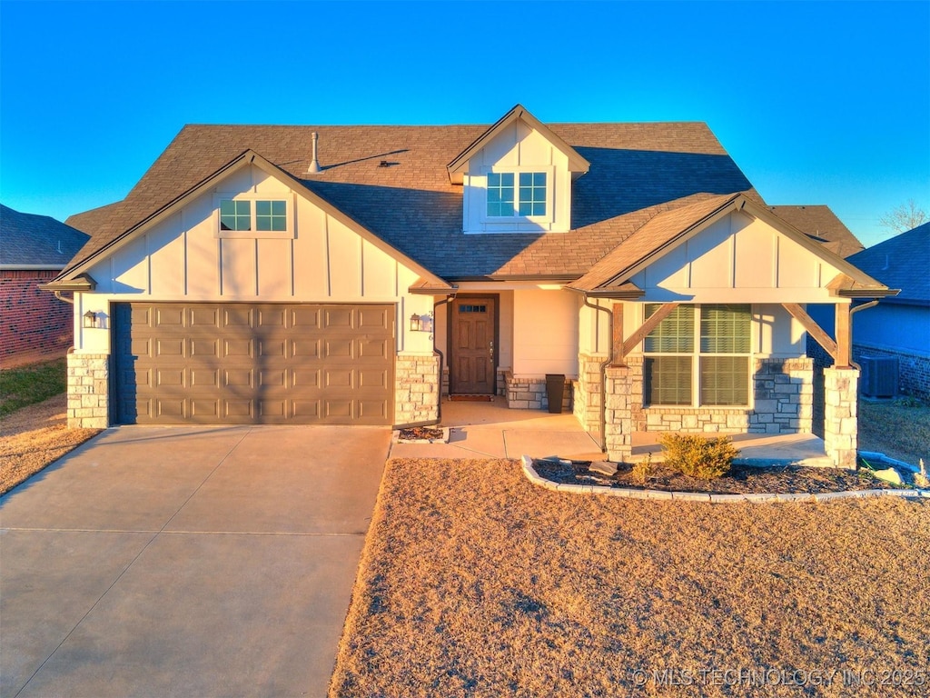 view of front facade with a garage and cooling unit