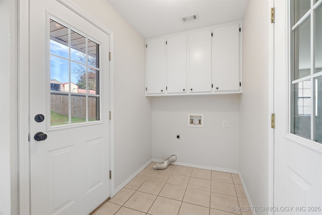 laundry area featuring washer hookup, hookup for an electric dryer, light tile patterned floors, and cabinets