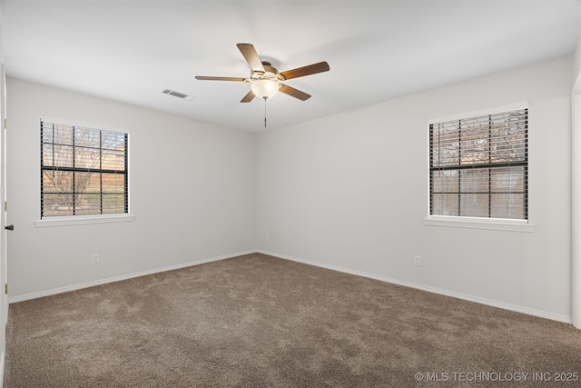 carpeted spare room with ceiling fan