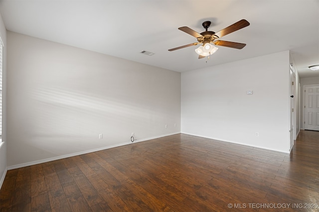 empty room featuring dark wood-type flooring and ceiling fan