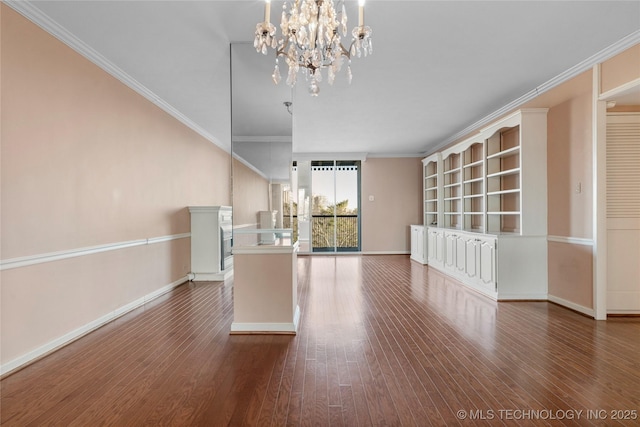 interior space with hardwood / wood-style floors, crown molding, and a notable chandelier