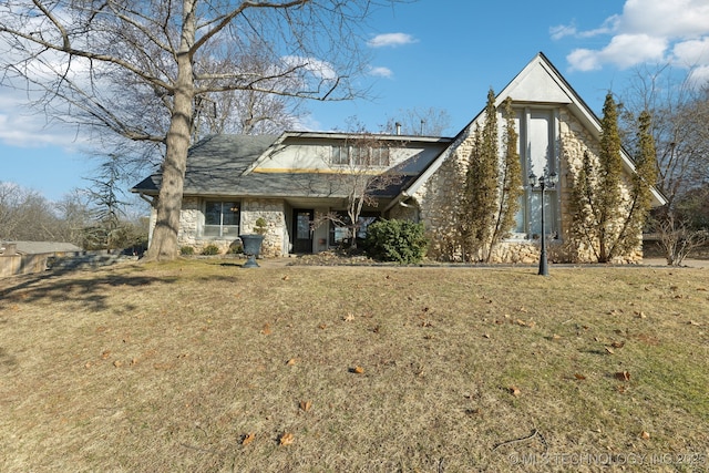 view of front facade with a front yard and stone siding