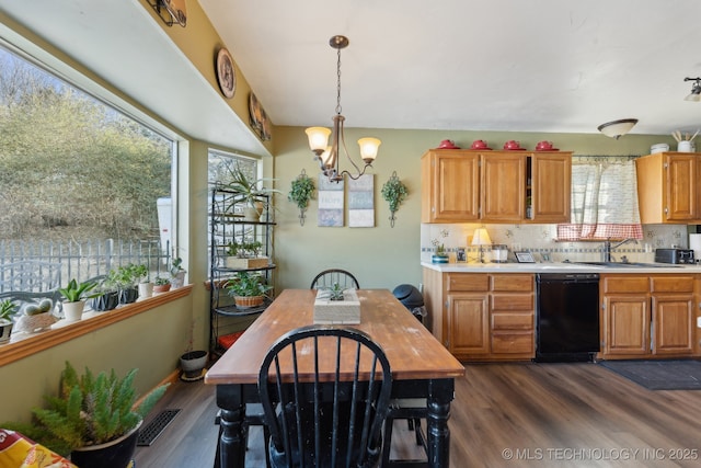 kitchen featuring dark wood-type flooring, sink, tasteful backsplash, decorative light fixtures, and dishwasher