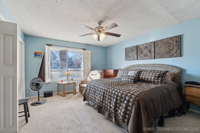 carpeted bedroom with a textured ceiling and ceiling fan