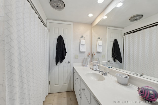 bathroom featuring tile patterned flooring and vanity