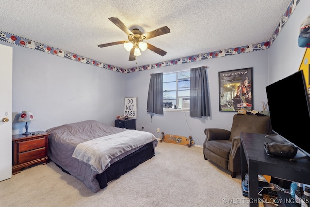 carpeted bedroom with ceiling fan and a textured ceiling