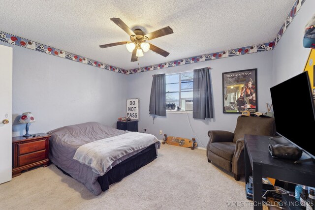 bedroom featuring light carpet, a textured ceiling, and ceiling fan